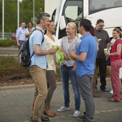 Guests enjoying food and drinks outside bus